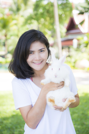 pretty girl holding white rabbit, petの写真素材