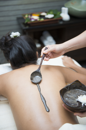 chiropractor pour coffee scrub into hand for massage, massageの写真素材