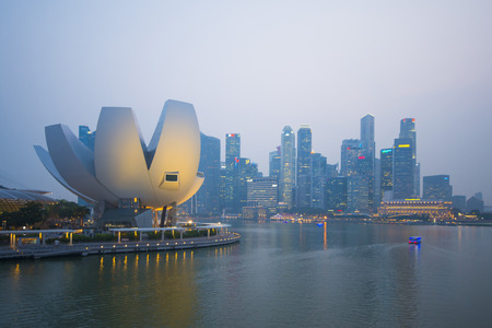 MARINA BAY SANDS, SINGAPORE OCTOBER 12, 2015: ArtScience Museum and skyscrapers in twilight time at Marina bay, Singapore on October 12, 2015, landmarkのeditorial素材