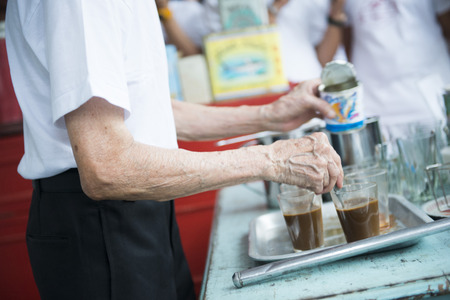 the old man making hot coffee thai style, beverageの写真素材