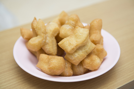 deep-fried dough stick on dish, breakfastの写真素材