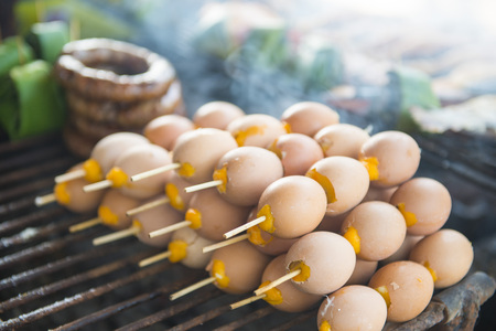 grilled egg on the charcoal stove at the market, foodの写真素材