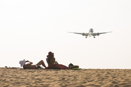 PHUKET, THAILAND - FEBRUARY 9, 2016 : airplane flying over beautiful beach at Mai Khao Beach, Phuket on february 9, 2016, outdoorのeditorial素材