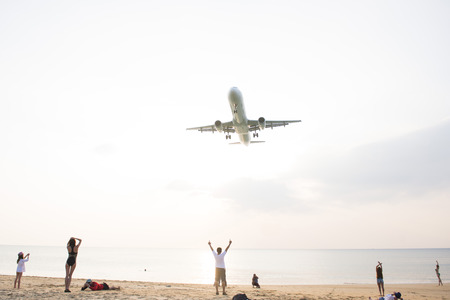 PHUKET, THAILAND - FEBRUARY 9, 2016 : airplane flying over beautiful beach at Mai Khao Beach, Phuket on february 9, 2016, outdoorのeditorial素材