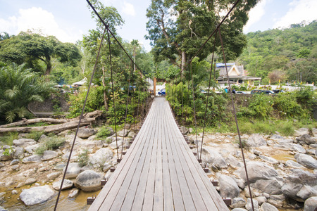 suspension bridge over the stream, woodenの写真素材