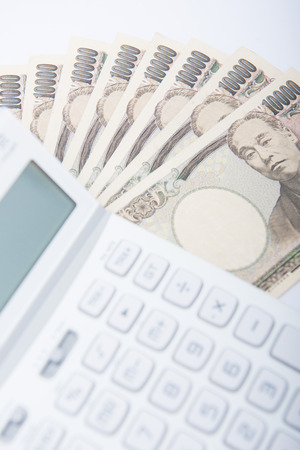 Japanese money banknotes with calculator, yenの写真素材