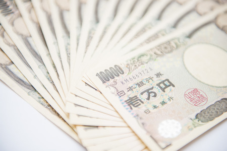 Pile of Japanese ten thousand yen banknotes, cashの写真素材