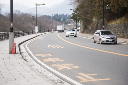 NIKKO, JAPAN - FEBRUARY 19, 2016 : Street in Nikko among the beautiful nature on Feb 19, 2016, transportationのeditorial素材