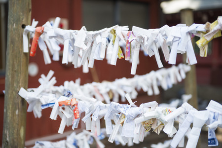 TOKYO, JAPAN - FEBRUARY 17, 2016 : Omikuji :: random fortune papers in shrines at Japan, Esiimsiのeditorial素材