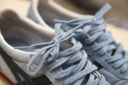 pair of blue sneakers with laces, footwear