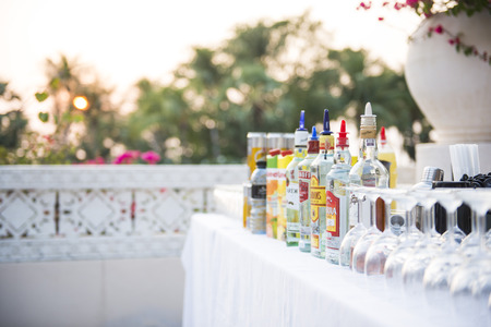 bottles of alcohol, wine glass and fruit juice on barのeditorial素材