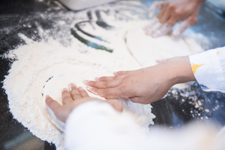 Chefs preparing the dough for pizza, flourの写真素材