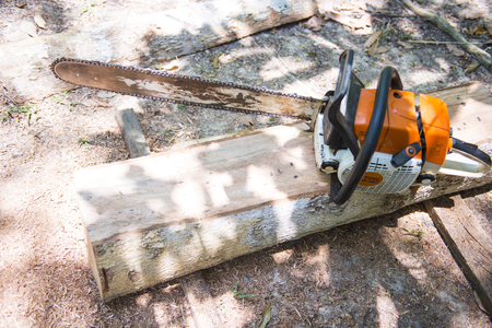 old chainsaw on the stump, equipmentのeditorial素材