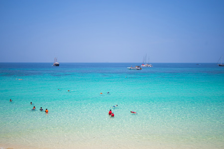 Mai Ton Island, Thailand - April 11, 2016 : Tourists are enjoying on tropical beach with blue sky, summerのeditorial素材