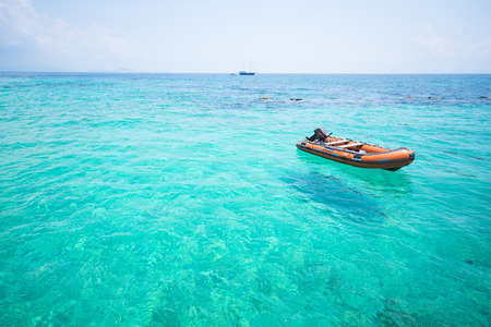 orange rubber boat floating on the sea, ocean