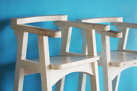old white wooden chair with blue wall, architectureの写真素材