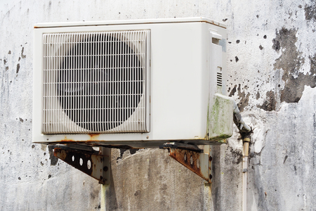 old air conditioner hanging on wall, electricalの写真素材