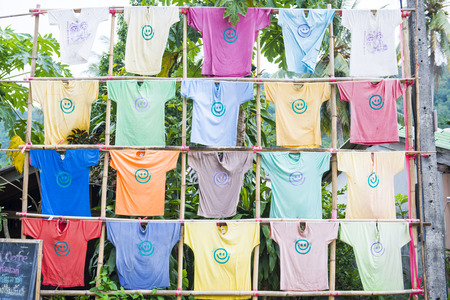 colorful t-shirt hanging on bamboo for decoration, clothingの写真素材