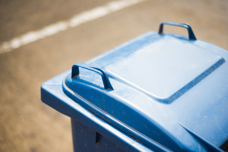 blue plastic trash can by the roadside, garbageの写真素材