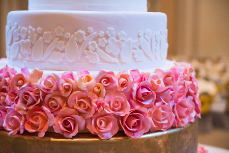 Wedding cake decorated with flower in ballroomの写真素材