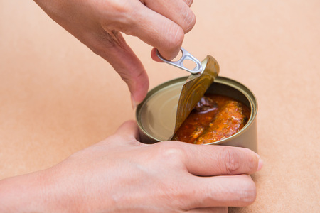 open canned fish by ring pull, canned foodの写真素材