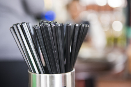 black chopsticks in stainless tube, equipmentの写真素材