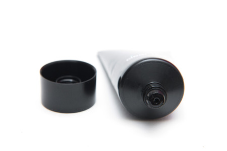 Skincare in black plastic tube isolated on white background, lotionの写真素材