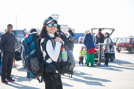 Nepal - 3 January 2017 ::woman backpacker carry her backpack at Kathmandu airport , Nepalのeditorial素材