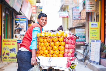 Nepal - 3 January 2017 :: Nepalese merchant sell orange on the bicycle , Nepalのeditorial素材