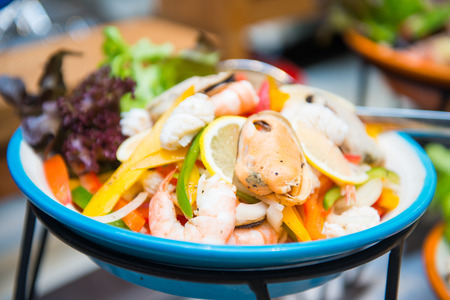 seafood mix with vegetable and salad dressing , foodの写真素材
