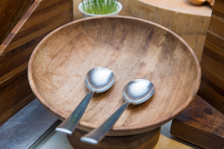 spoon and wooden bowl for cooking salad , equipmentの写真素材