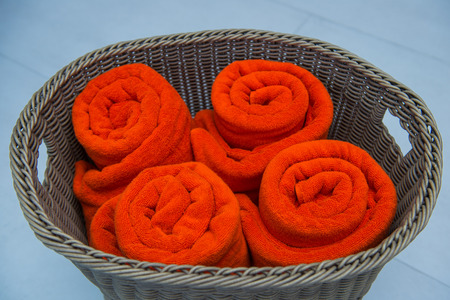 orange rolled towels in basket, softの写真素材