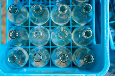 empty water bottle in blue plastic crates, glassの写真素材