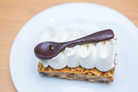 Almond cake topped with whipped cream, dessertの写真素材