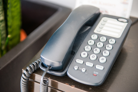 Black telephone on the desk in office, communication