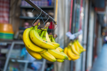 Fresh banana hanging in shop for sale in market, fruitの写真素材