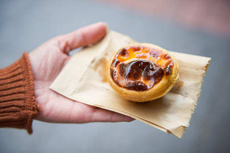 Sweet egg tart custard pie on woman's hand, dessertの写真素材