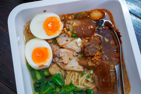 Noodles soup with pork leg and egg, thai spicy noodles