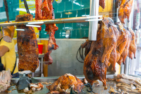 Rows of roast ducks with crispy pork and roasted red pork in chinese restaurantの写真素材
