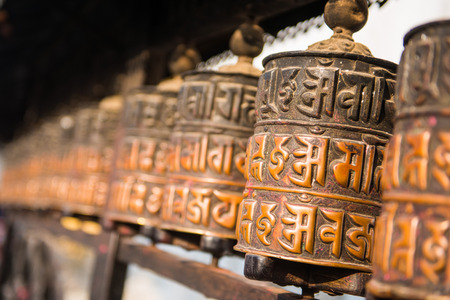 Buddhist prayer wheels at the Monkey Temple in Nepal, landmarkの写真素材