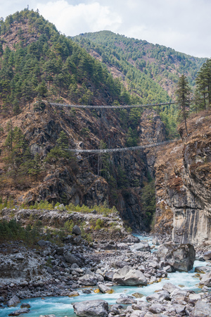 suspension bridge for cross the river on mountain, Nepalの写真素材