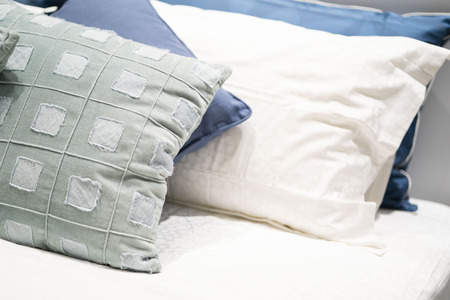 scatter cushion on the bed in bedroom,pillowの写真素材