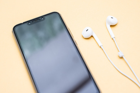 black smartphone and white earphone,electronic
