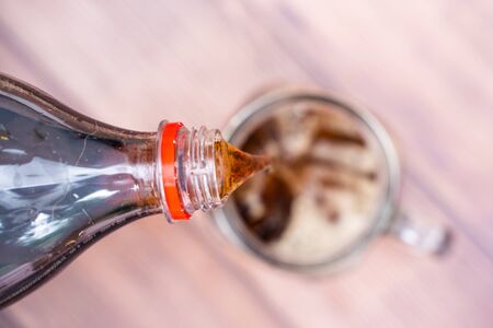 pouring cola sparkling water into a glass,sodaの写真素材