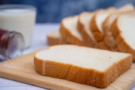 sliced bread with jam and milk for breakfast,food