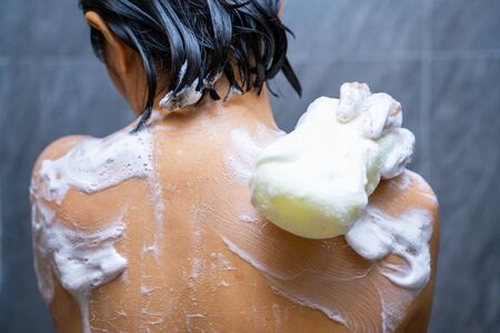 woman shower with body scrub sponge,showerの写真素材
