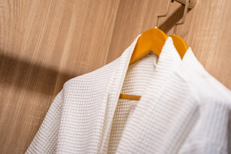 white bathrope hang in wardrobe,dressing gown