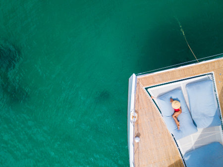 A woman sunbathing on a  catamaran boat,sunbatheの写真素材