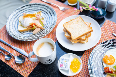 eating egg and toast in breakfast at restaurant,foodsの写真素材