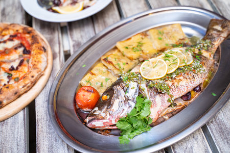 Baked fish with potatoes and sauce,Italian foodの写真素材